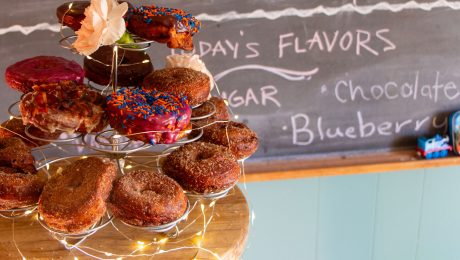 Donut tower on a table with todays flavors on a chalkboard